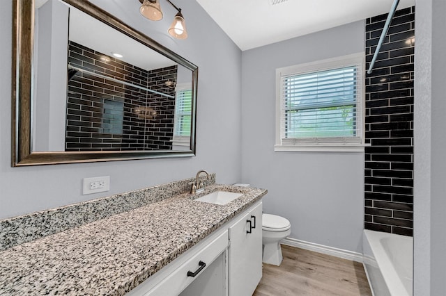 110 W Moore St, Sherman, TX 75090 - bathroom featuring vanity, toilet, wood finished floors, and baseboards