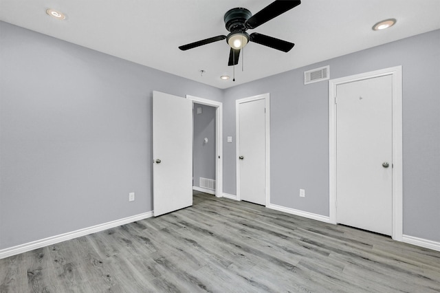 110 W Moore St, Sherman, TX 75090 - unfurnished bedroom featuring wood finished floors, baseboards, two closets, and a ceiling fan