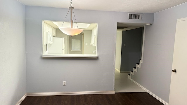4503 N O Connor Rd Unit 1113, Irving, TX 75062 - unfurnished room with dark wood-style flooring, baseboards, and stairs