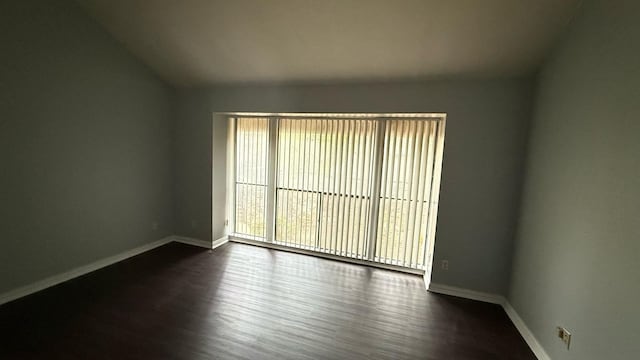 4503 N O Connor Rd Unit 1113, Irving, TX 75062 - unfurnished room with dark wood-style floors, baseboards, and vaulted ceiling