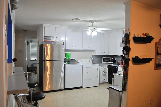 5328 Ira St N, Haltom City, TX 76117 - kitchen with appliances with stainless steel finishes, independent washer and dryer, ceiling fan, white cabinets, and light countertops