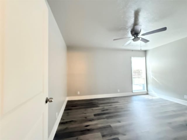 980 S Weatherred Dr Unit A, Richardson, TX 75080 - unfurnished room with wood finished floors, baseboards, and a ceiling fan
