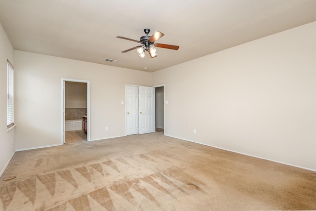 2038 La Salle Trl, Grand Prairie, TX 75052 - unfurnished bedroom featuring light carpet, connected bathroom, and ceiling fan