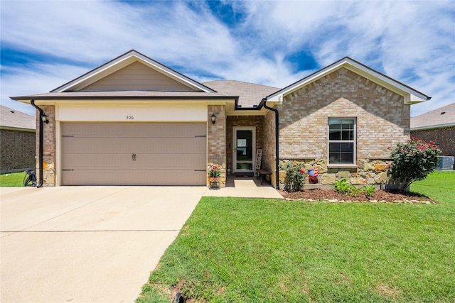 306 Breaux Ln, Mabank, TX 75147 - ranch-style home featuring a front lawn, concrete driveway, a garage, central air condition unit, and stone siding