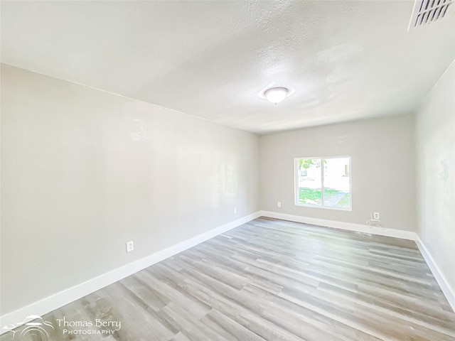 2234 Meander St, Abilene, TX 79602 - spare room with wood finished floors, baseboards, and a textured ceiling