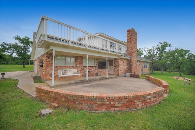 290 Berwick Rd, Jacksboro, TX 76458 - back of property featuring a patio, a chimney, a lawn, and brick siding