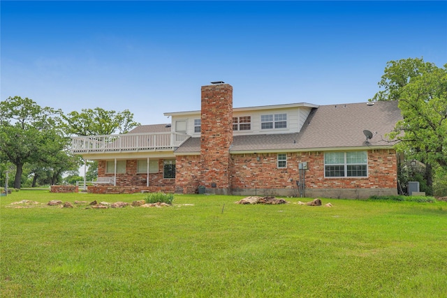 290 Berwick Rd, Jacksboro, TX 76458 - back of house with brick siding, a yard, a chimney, roof with shingles, and a wooden deck