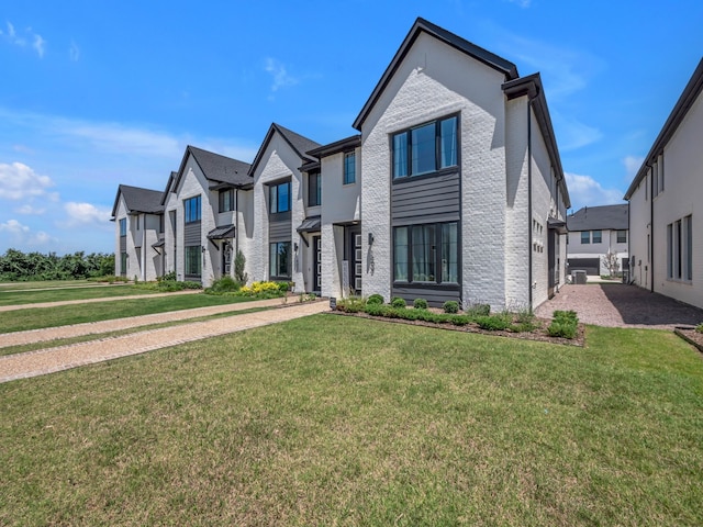 1409 Silver Marten Trl, Arlington, TX 76005 - view of front of home featuring a front yard, brick siding, a residential view, and central AC