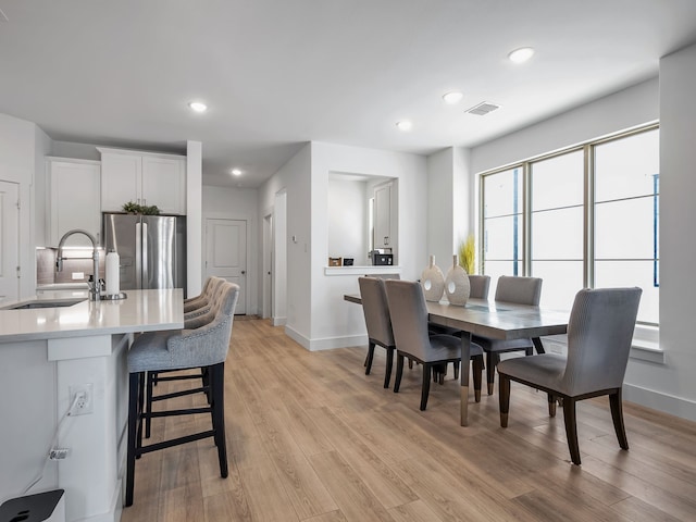 1409 Silver Marten Trl, Arlington, TX 76005 - dining area featuring light wood finished floors, baseboards, and recessed lighting