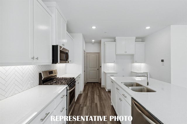 1387 Union Rd, Celina, TX 75009 - kitchen with appliances with stainless steel finishes, a sink, dark wood-style flooring, white cabinetry, and recessed lighting