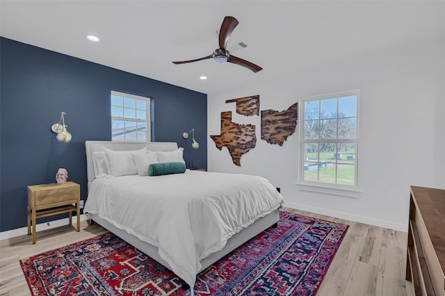4491 Dugan Chapel Rd, Bells, TX 75414 - bedroom featuring multiple windows, light wood-style flooring, recessed lighting, a ceiling fan, and baseboards