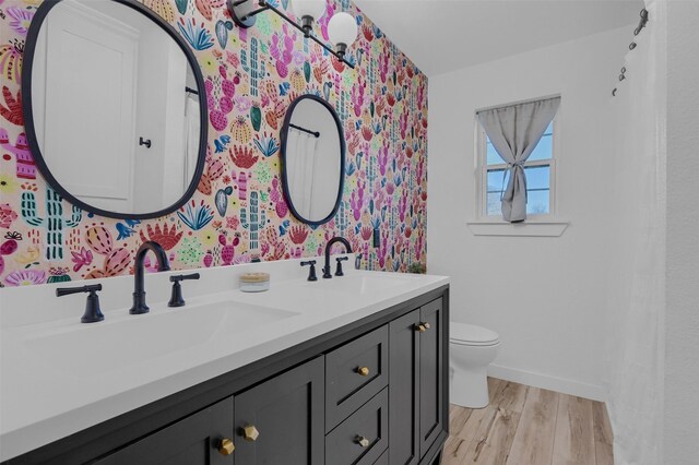 4491 Dugan Chapel Rd, Bells, TX 75414 - full bathroom featuring double vanity, wood finished floors, toilet, and baseboards