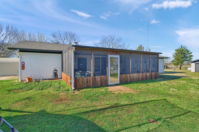 4491 Dugan Chapel Rd, Bells, TX 75414 - rear view of house with a sunroom, a lawn, brick siding, and roof with shingles
