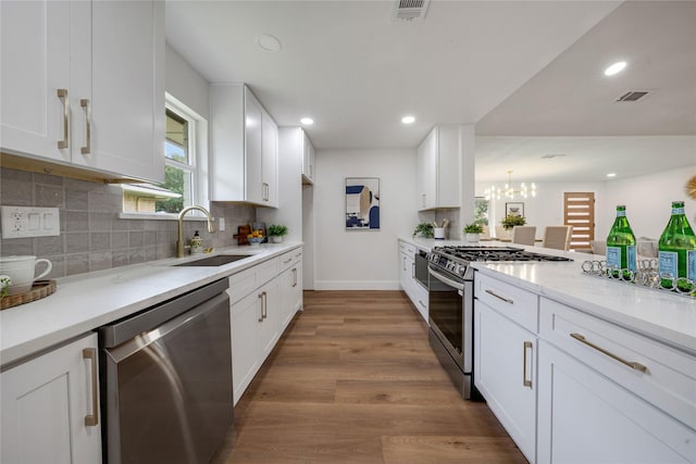 2520 Delmar Dr, Plano, TX 75075 - kitchen with appliances with stainless steel finishes, white cabinetry, recessed lighting, and backsplash