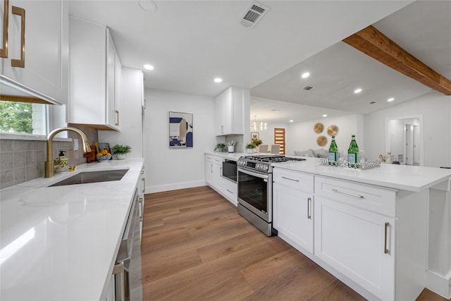 2520 Delmar Dr, Plano, TX 75075 - kitchen featuring stainless steel appliances, light wood-type flooring, a peninsula, recessed lighting, and backsplash