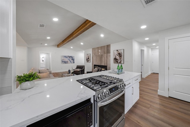 2520 Delmar Dr, Plano, TX 75075 - kitchen with gas stove, open floor plan, light stone countertops, recessed lighting, and wood finished floors
