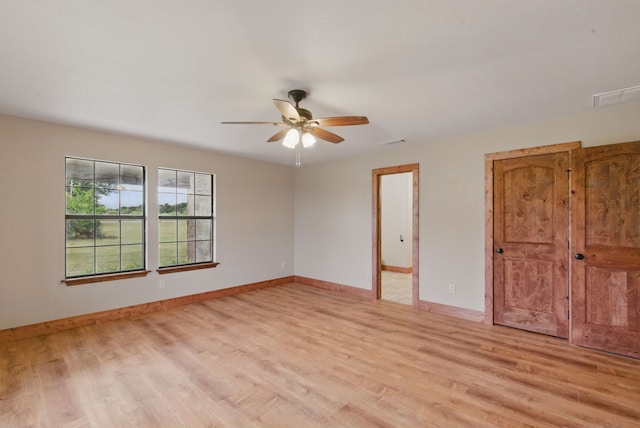 2790 Fairview Rd, Millsap, TX 76066 - unfurnished bedroom featuring light wood-style floors, baseboards, and a ceiling fan