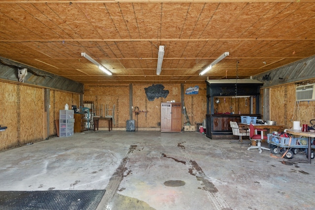 2790 Fairview Rd, Millsap, TX 76066 - garage featuring a wall mounted AC and a workshop area