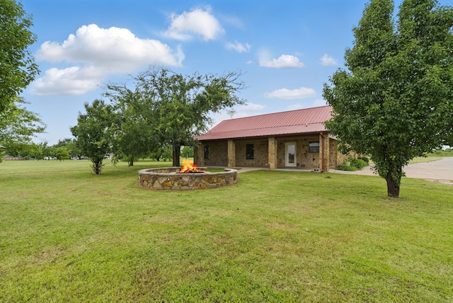 2790 Fairview Rd, Millsap, TX 76066 - back of house featuring a lawn, a fire pit, and metal roof