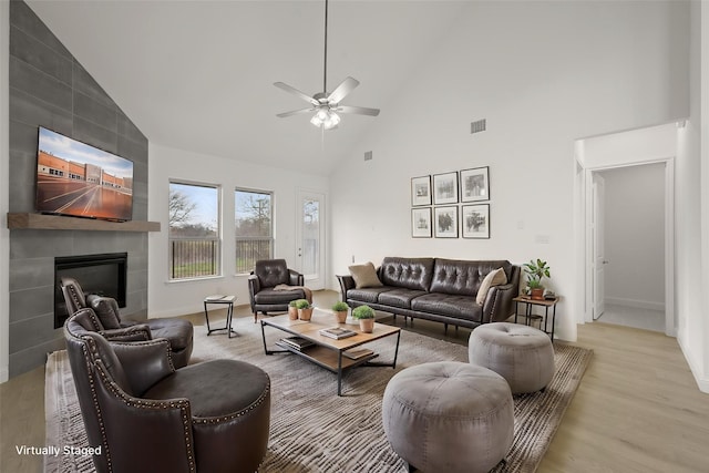 1016 Allegheny Ct, Burleson, TX 76028 - living area with high vaulted ceiling, ceiling fan, a fireplace, wood finished floors, and baseboards