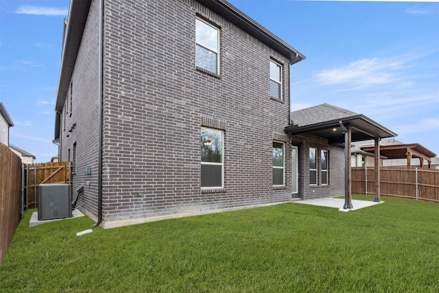 1016 Allegheny Ct, Burleson, TX 76028 - rear view of house featuring central air condition unit, brick siding, and a patio area