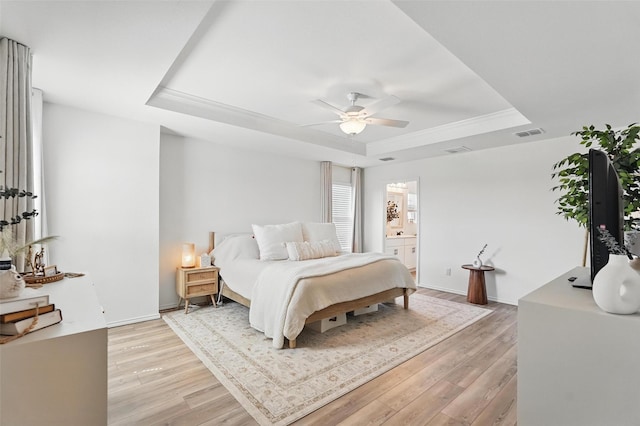 1943 Applewood Trl, Forney, TX 75126 - bedroom with a tray ceiling, light wood finished floors, connected bathroom, ceiling fan, and crown molding