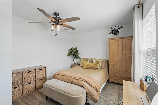 1943 Applewood Trl, Forney, TX 75126 - bedroom with wood finished floors, multiple windows, and a ceiling fan