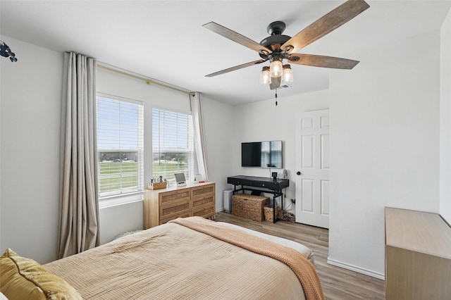 1943 Applewood Trl, Forney, TX 75126 - bedroom with wood finished floors, a ceiling fan, and baseboards