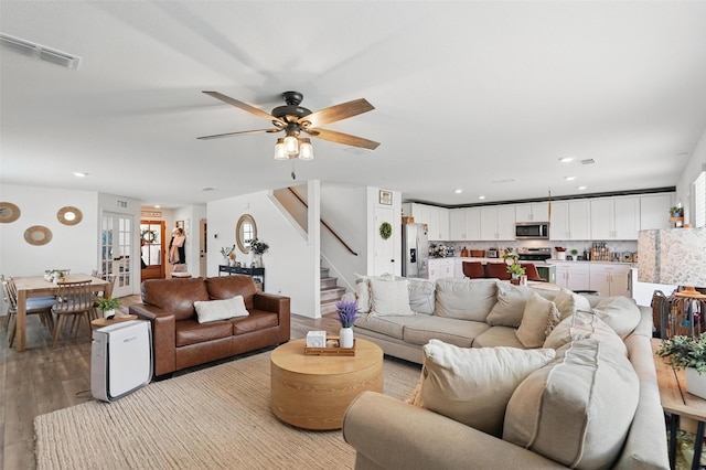 1943 Applewood Trl, Forney, TX 75126 - living room featuring light wood-style flooring, stairway, ceiling fan, recessed lighting, and french doors