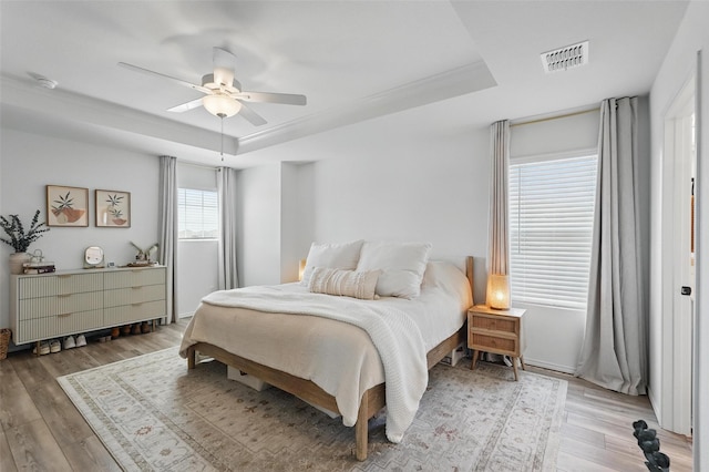 1943 Applewood Trl, Forney, TX 75126 - bedroom featuring a raised ceiling, light wood-style flooring, and ceiling fan