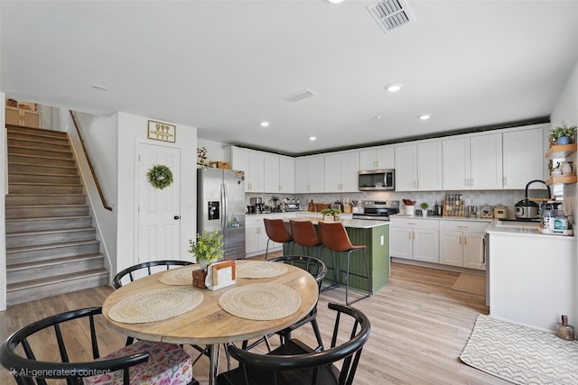 1943 Applewood Trl, Forney, TX 75126 - dining space with light wood-style floors, stairs, and recessed lighting