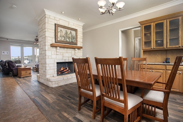 4816 Prairie Chapel Trl, Crandall, TX 75114 - dining area featuring ornamental molding, a fireplace, a chandelier, dark wood-type flooring, and a ceiling fan
