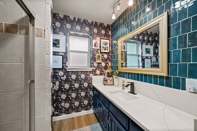 3721 Oakbriar Ln, Colleyville, TX 76034 - bathroom with wallpapered walls, vanity, baseboards, and wood finished floors