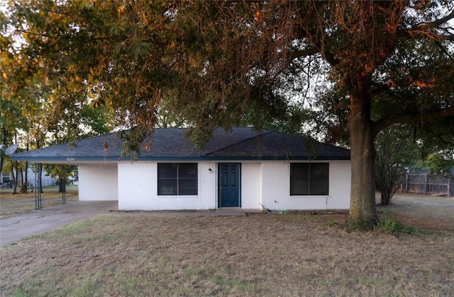 1030 Tyler St, Cooper, TX 75432 - ranch-style house with a carport, a shingled roof, driveway, and stucco siding