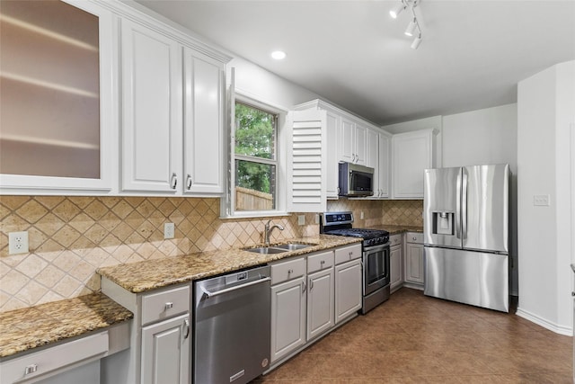 230 Sweetheart Ln, Longview, TX 75605 - kitchen featuring appliances with stainless steel finishes, a sink, and white cabinets