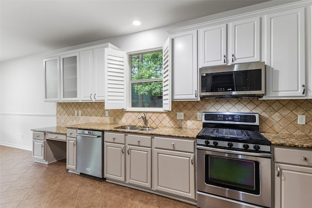 230 Sweetheart Ln, Longview, TX 75605 - kitchen featuring stainless steel appliances, a sink, light stone countertops, white cabinetry, and recessed lighting