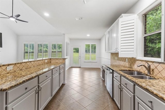230 Sweetheart Ln, Longview, TX 75605 - kitchen with stainless steel dishwasher, a sink, backsplash, a ceiling fan, and recessed lighting