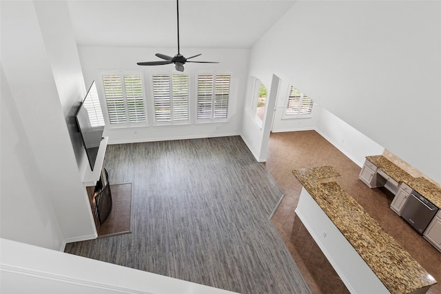 230 Sweetheart Ln, Longview, TX 75605 - unfurnished living room with plenty of natural light, a ceiling fan, vaulted ceiling, and baseboards