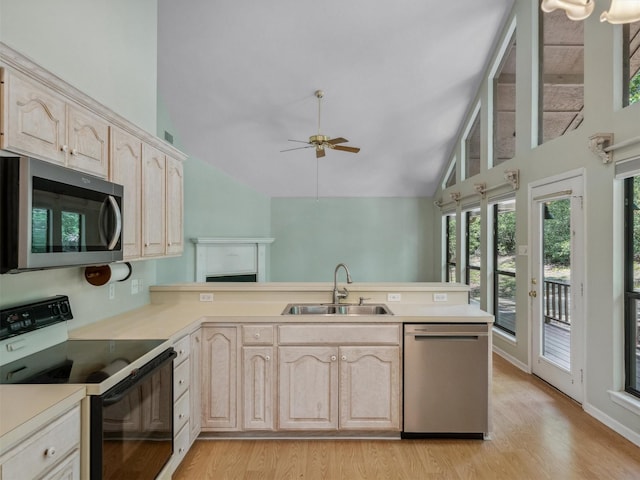 136 Lariat Loop, Holly Lake Ranch, TX 75765 - kitchen featuring stainless steel appliances, a sink, a peninsula, ceiling fan, and light wood-type flooring