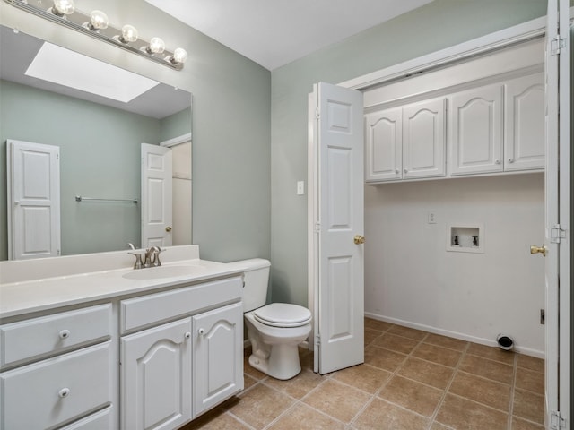 136 Lariat Loop, Holly Lake Ranch, TX 75765 - bathroom with vanity, toilet, tile patterned floors, a skylight, and baseboards
