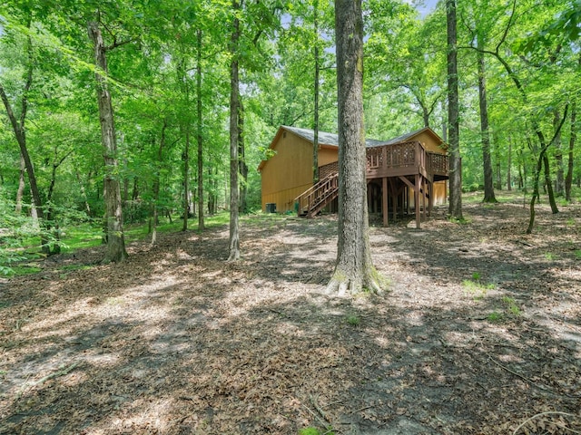 136 Lariat Loop, Holly Lake Ranch, TX 75765 - view of yard with stairway, a wooden deck, and a wooded view