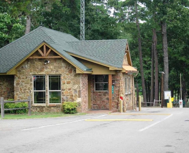 136 Lariat Loop, Holly Lake Ranch, TX 75765 - view of property with uncovered parking and view of wooded area