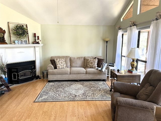 136 Lariat Loop, Holly Lake Ranch, TX 75765 - living area with vaulted ceiling, wood finished floors, and a wood stove