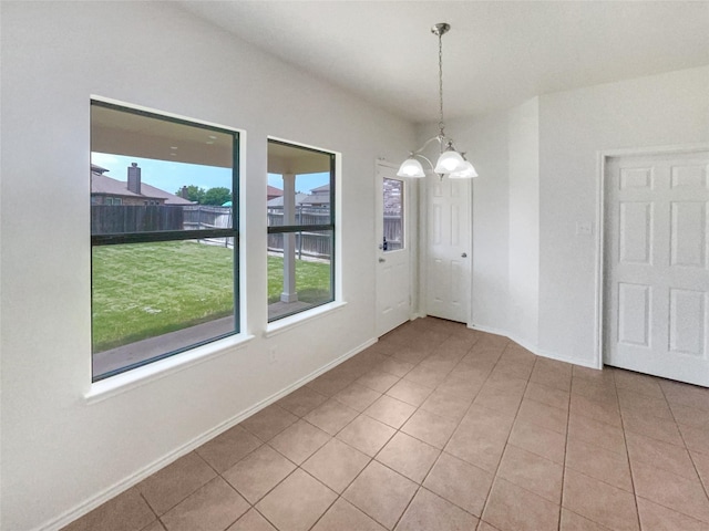 1017 Mule Deer Rd, Forney, TX 75126 - unfurnished dining area featuring a chandelier, baseboards, and tile patterned flooring