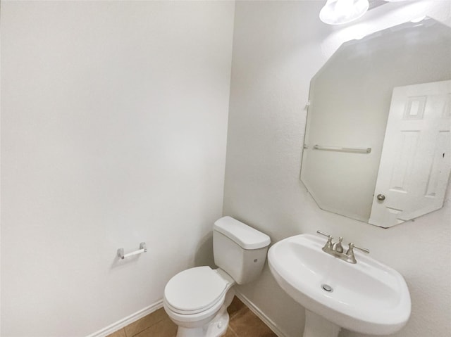 1017 Mule Deer Rd, Forney, TX 75126 - half bath featuring a sink, toilet, tile patterned flooring, and baseboards