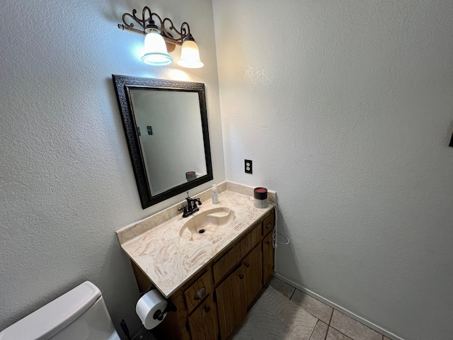 3377 W Moonlight Dr, Robinson, TX 76706 - bathroom featuring vanity, toilet, tile patterned flooring, and a textured wall