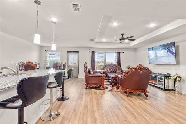 745 Brockwell Bnd, Forney, TX 75126 - living room featuring light wood finished floors, ceiling fan, a tray ceiling, and recessed lighting