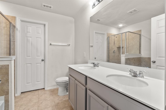 745 Brockwell Bnd, Forney, TX 75126 - full bathroom with double vanity, tiled shower, tile patterned flooring, and toilet