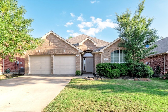 3072 Bigleaf Dr, Little Elm, TX 75068 - view of front facade with a garage, brick siding, driveway, and a front yard