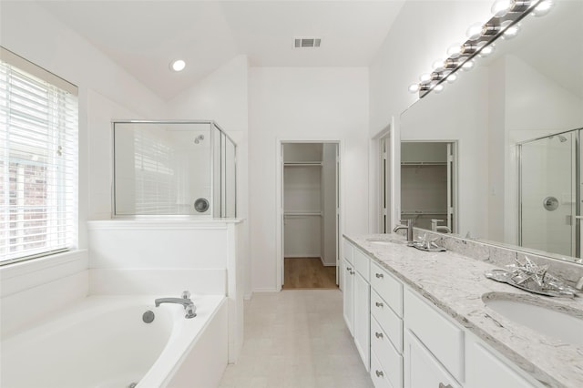 3072 Bigleaf Dr, Little Elm, TX 75068 - bathroom featuring a spacious closet, a stall shower, a garden tub, double vanity, and recessed lighting